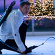 Jeremy Renner kneeling on the ice.